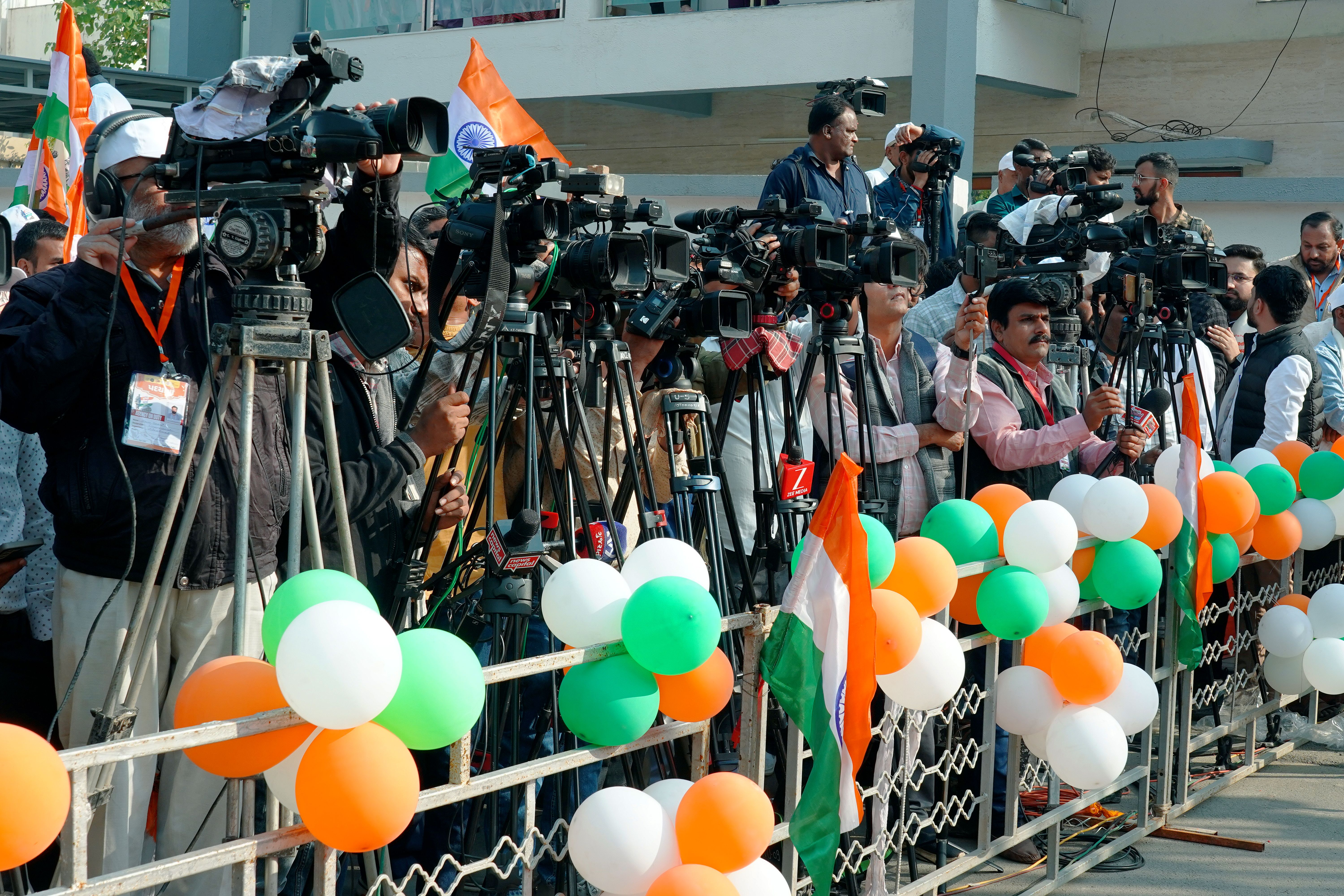 Journalists and videographers with cameras covering an event in Ahmedabad