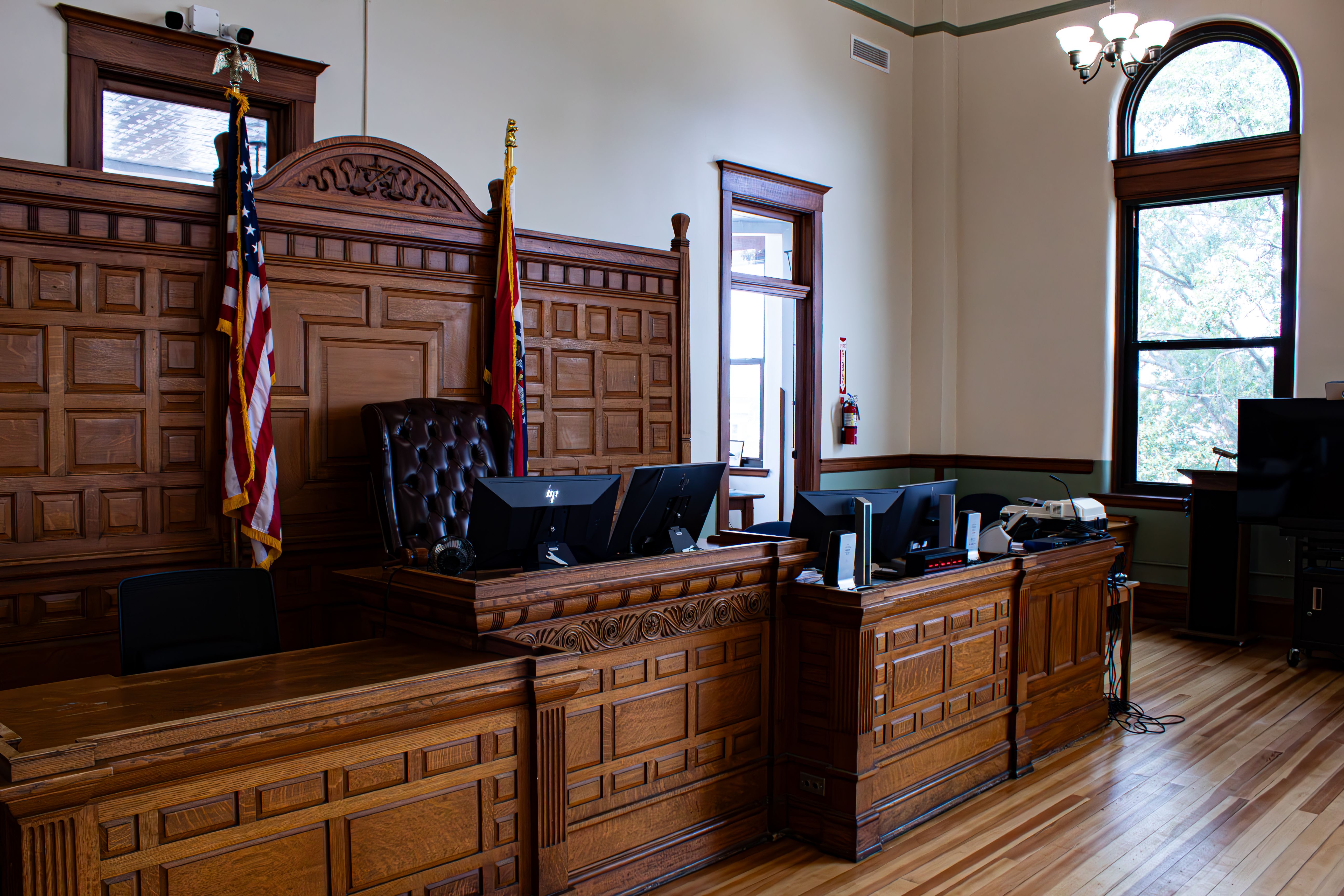 Interior view of an American courthouse with judge's desk and flags