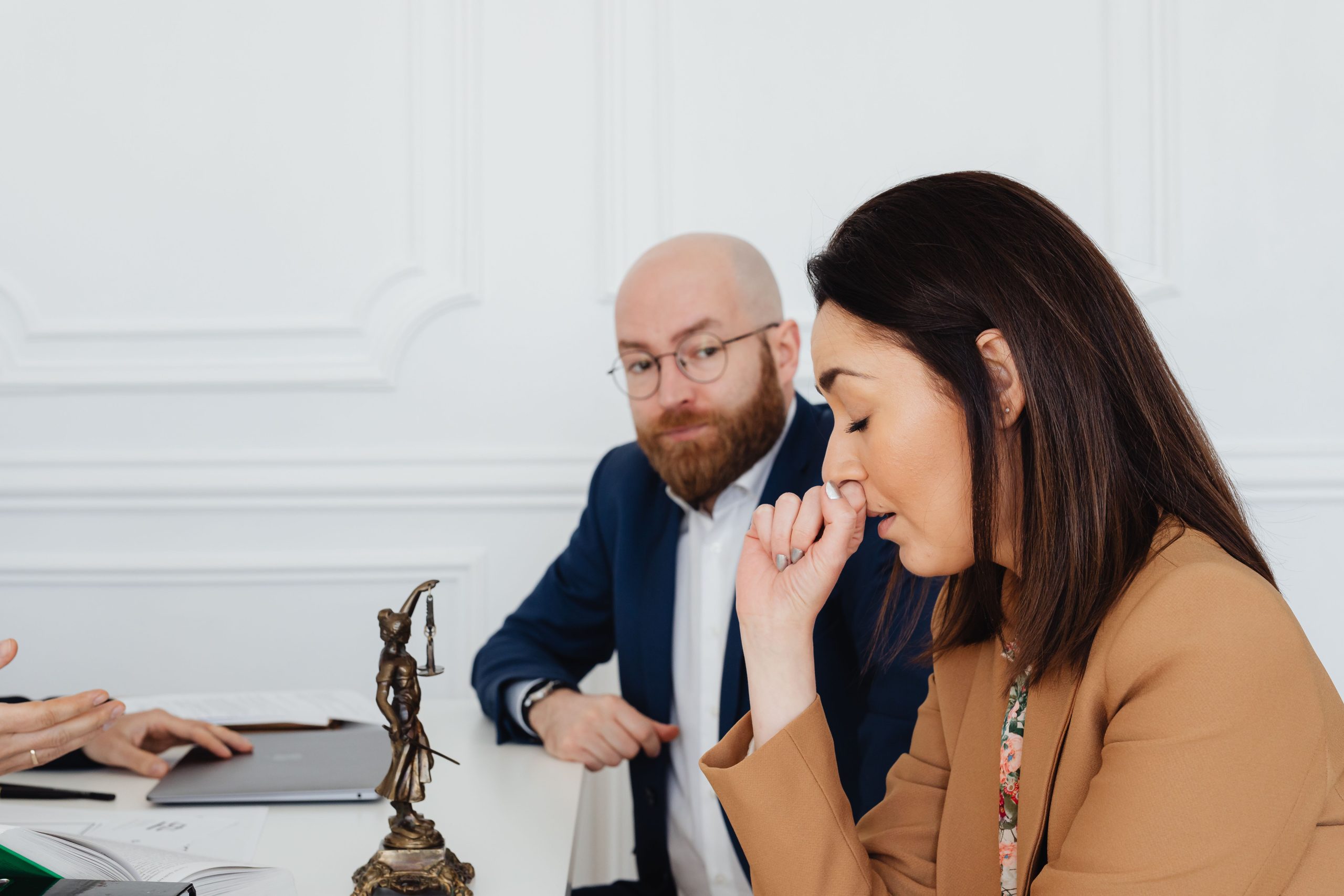Lawyers in serious discussion at a law office representing large-scale litigation strategy