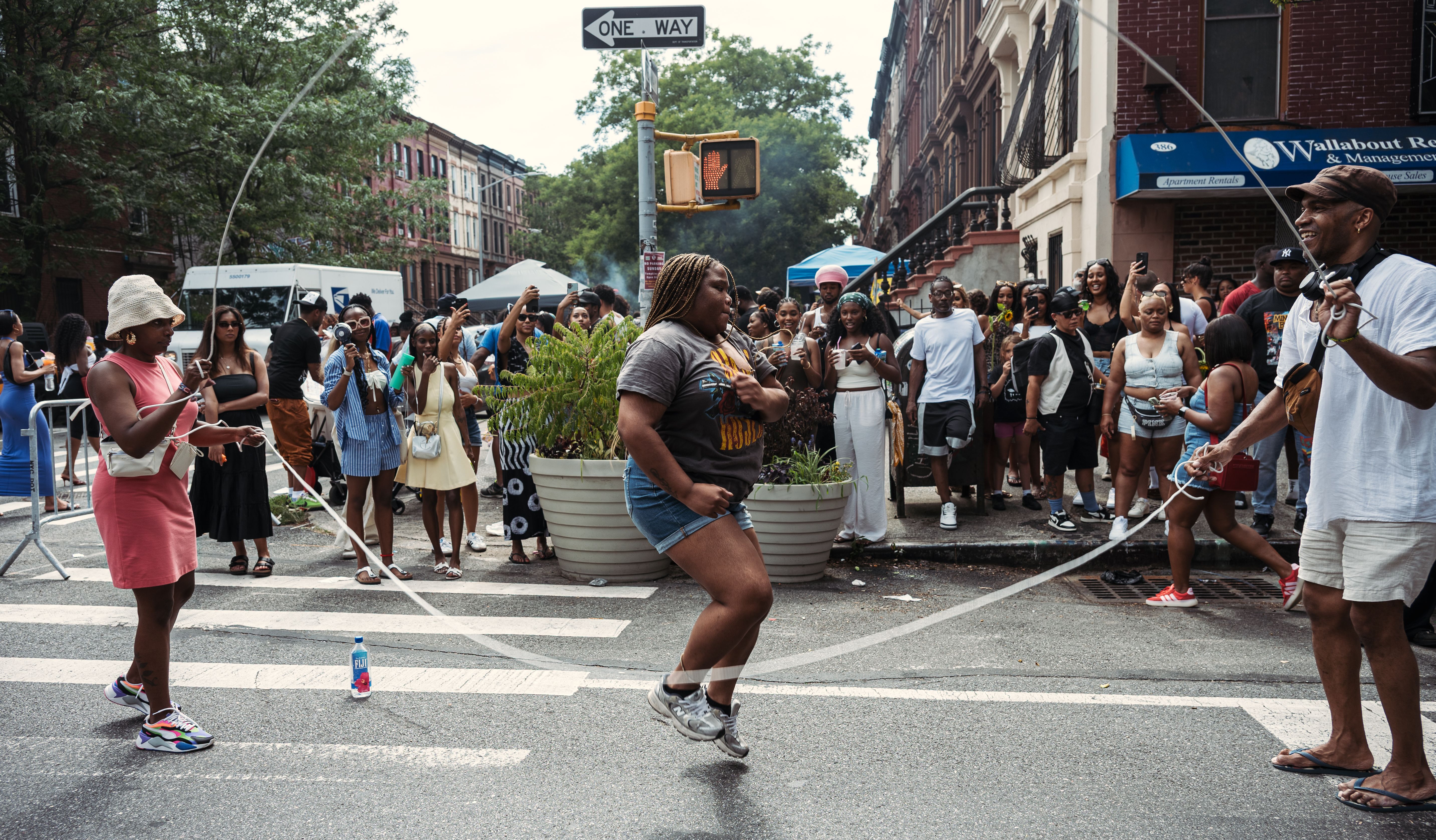 Neighbors enjoying a joyful block party with jump rope and street festivities
